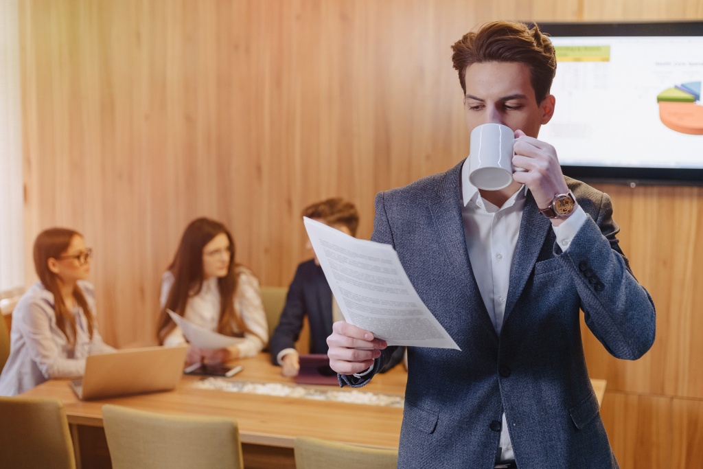 stylish-man-jacket-shirt-with-cup-coffee-his-hand-stands-reads-documents.jpg сотрудники
